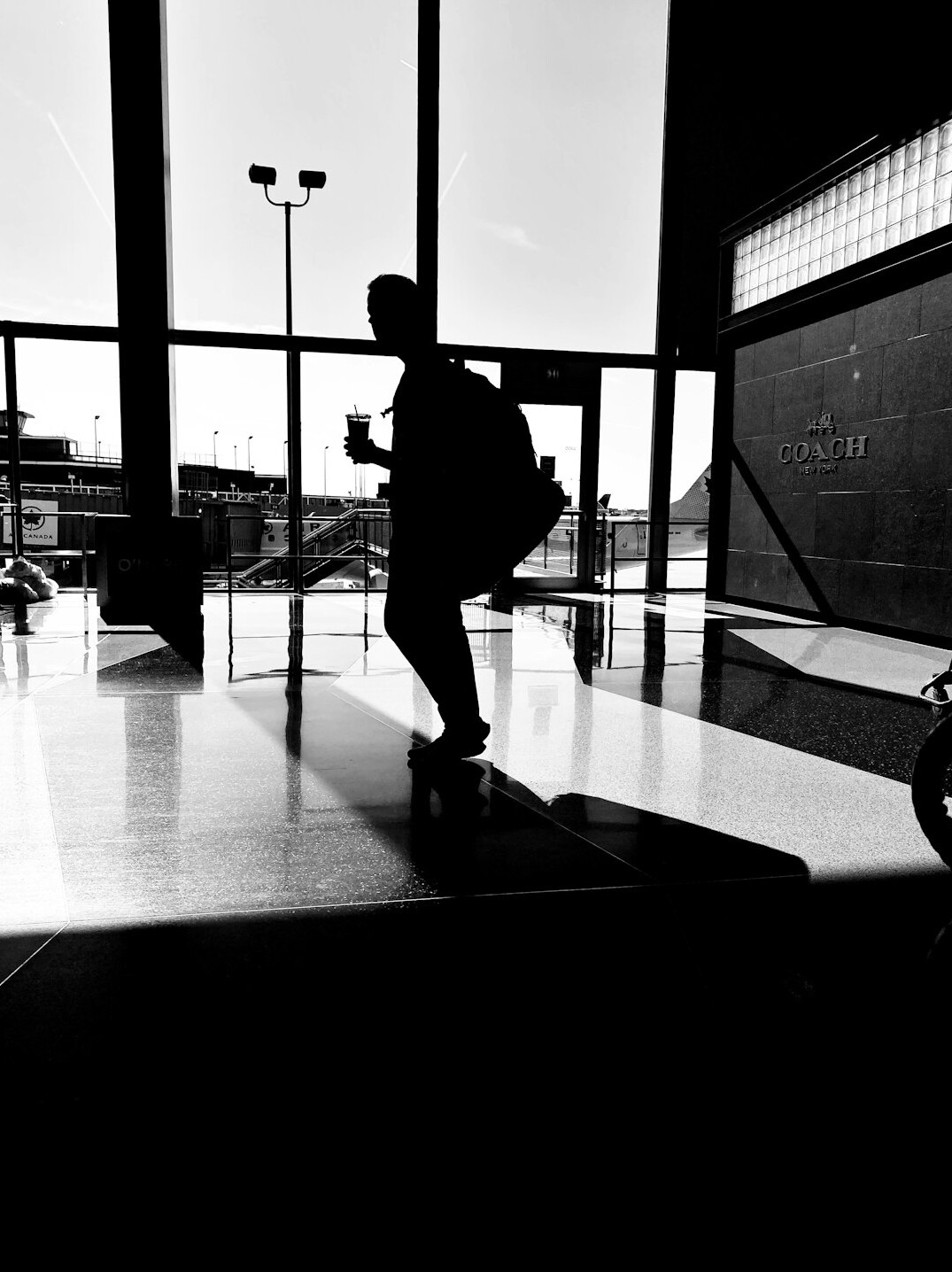 Traveler with suitcase and passport walking through an airport