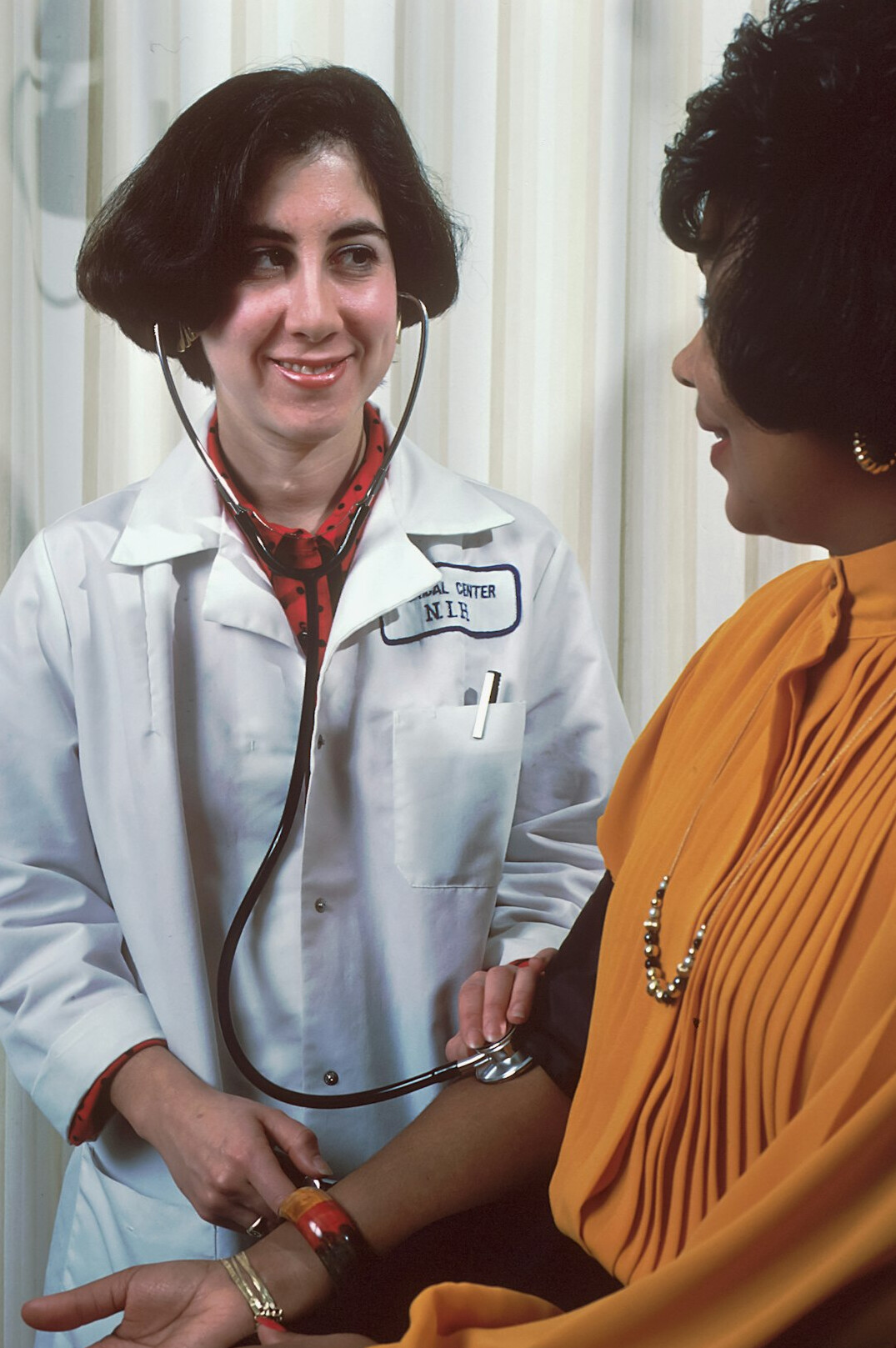 Doctor consulting with an elderly patient in a bright clinic room